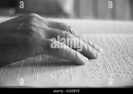 Person`s hand reading book in braille close up Stock Photo